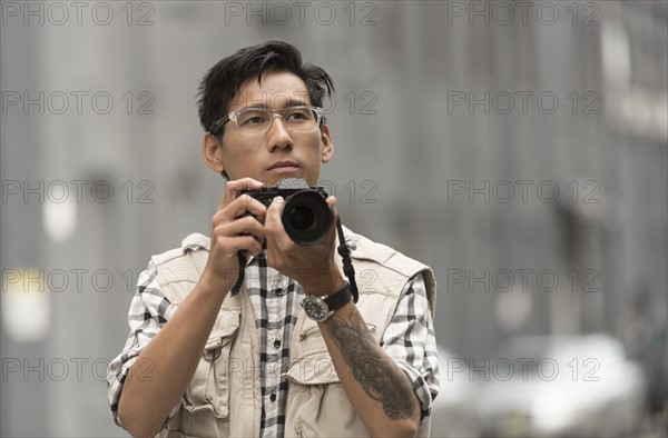 Portrait of man holding camera.