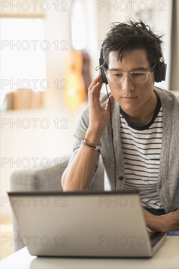 Man mixing music on laptop.