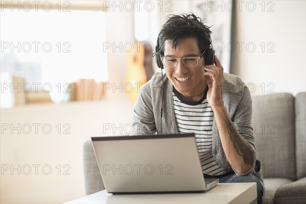 Man mixing music on laptop.