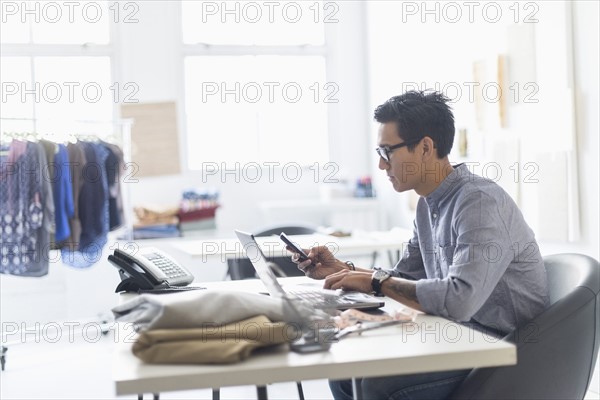 Side view of man working in studio.