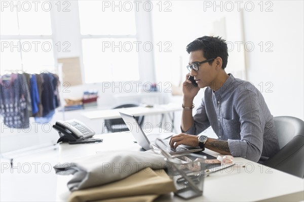 Side view of man working in studio.