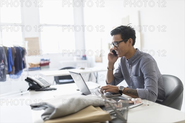 Side view of man working in studio.