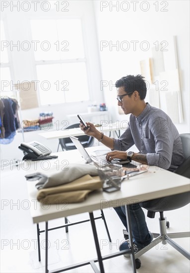 Side view of man working in studio.