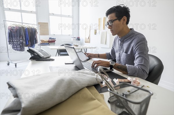 Fashion designer working in studio.