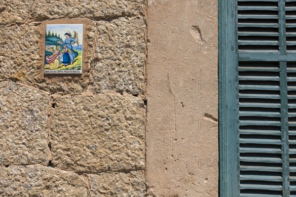 Close up of tile with angels on wall. Valldemossa, Mallorca, Spain.