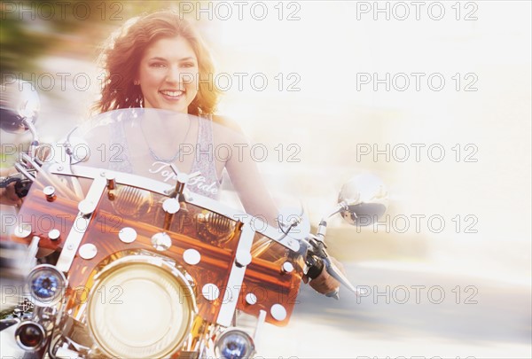 Young woman riding motorcycle.