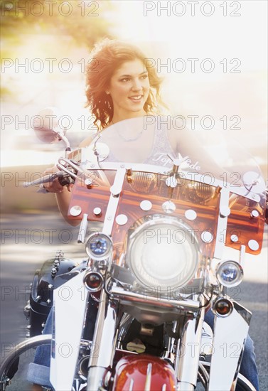 Young woman riding motorcycle.