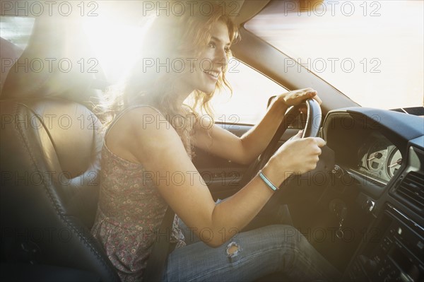 Young woman driving car.