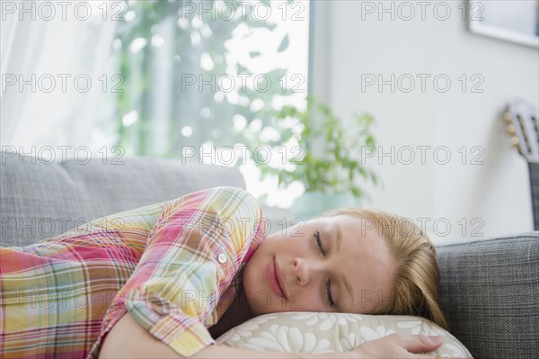 Young woman napping on sofa