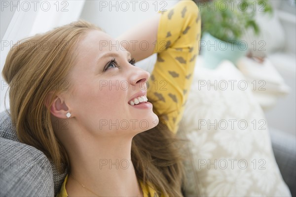 Young woman relaxing on sofa