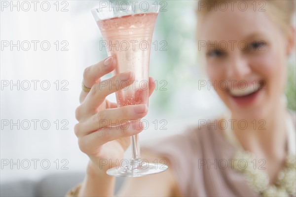 Young woman toasting with champagne