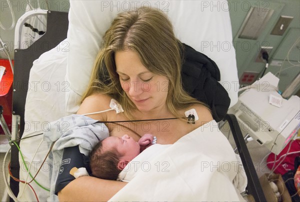 Mother holding newborn daughter