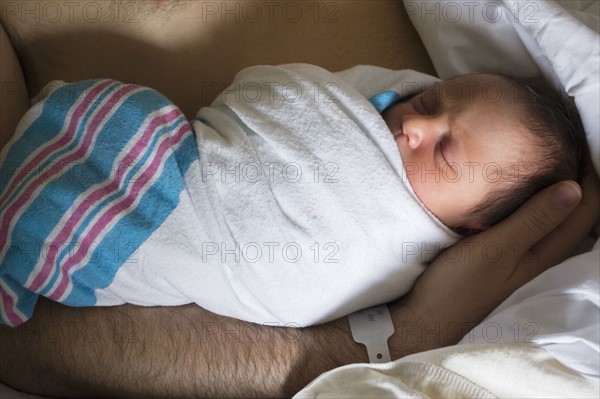 Father holding newborn daughter