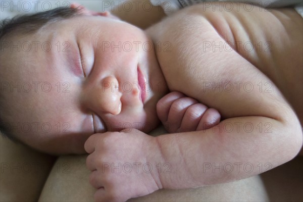 Mother holding newborn daughter