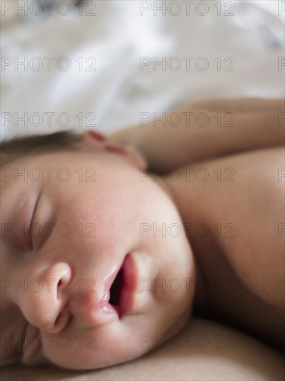 Mother holding newborn daughter