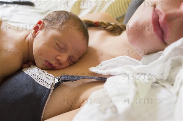 Mother holding newborn daughter