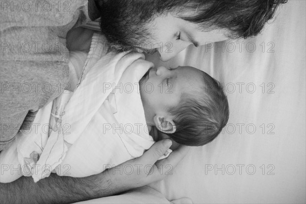 Father holding newborn daughter