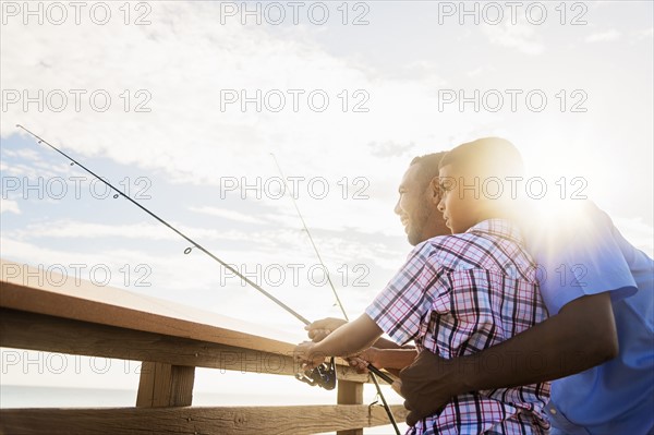 Father and son (10-11) fishing