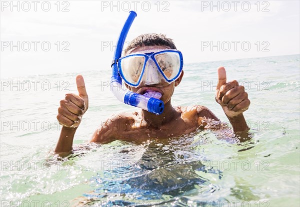 Boy (10-11) snorkeling in sea