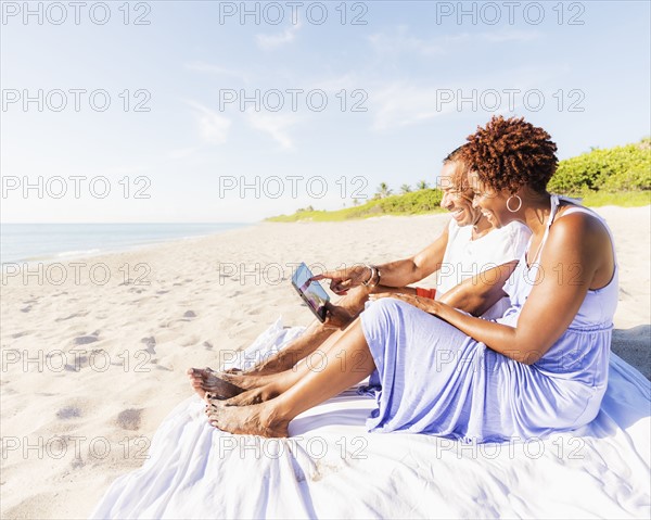 Man and woman sitting on beach