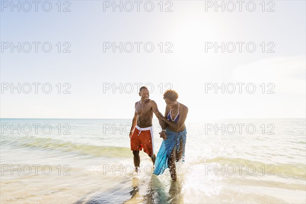 Mature couple walking in sea