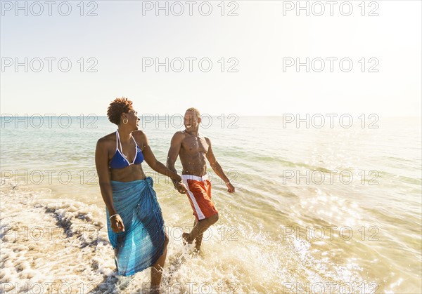 Mature couple walking in sea