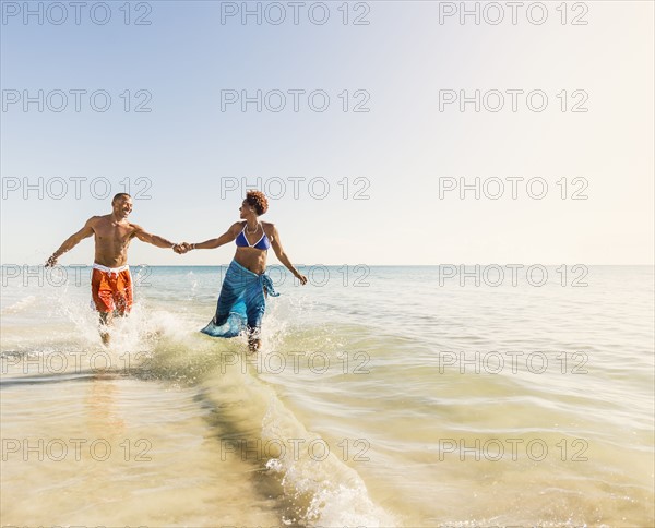 Mature couple running in sea