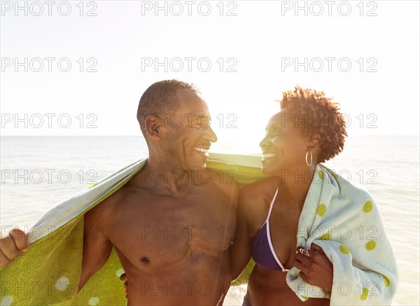 Mature couple embracing on beach