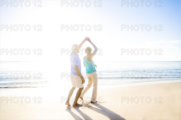 Mature couple dancing on beach