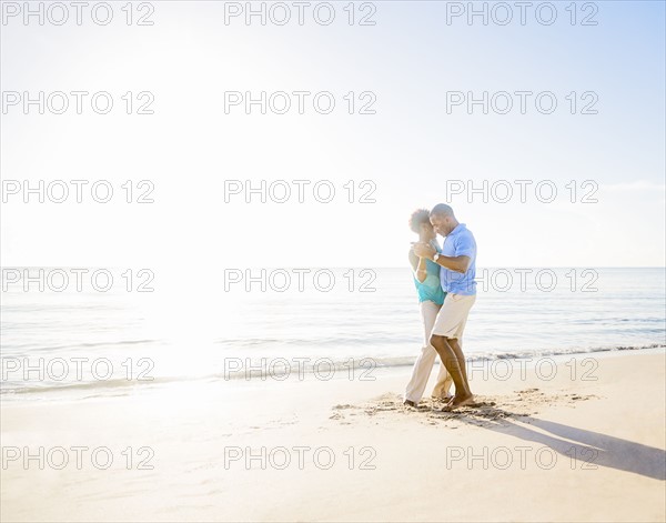 Mature couple dancing on beach