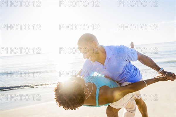 Mature couple dancing on beach