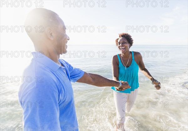 Mature couple walking on beach