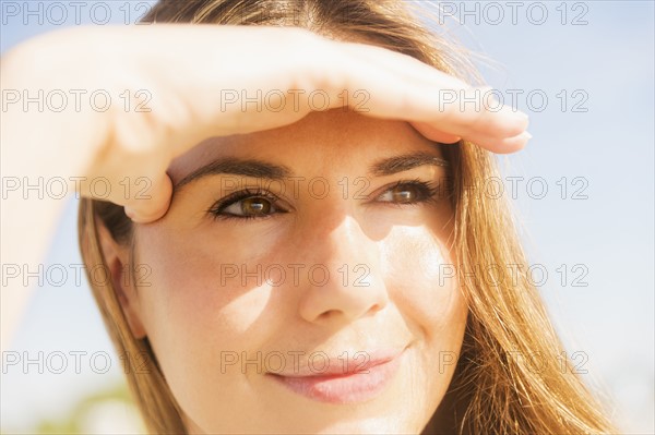 Woman shielding eyes