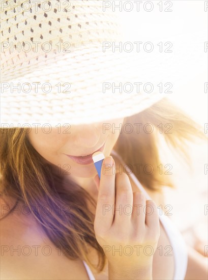 Woman applying lip balm