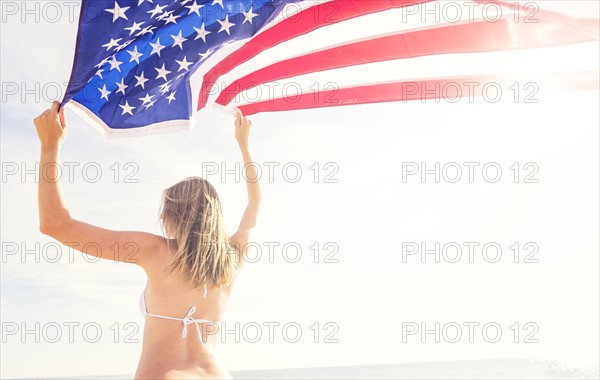 Woman holding American flag