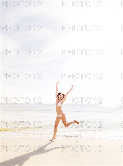 Woman jumping on beach