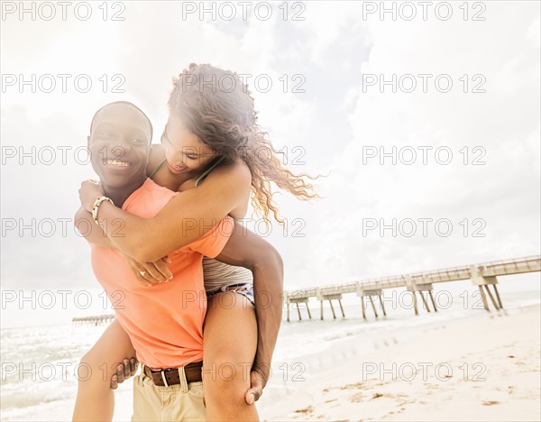 Young couple playing on beach