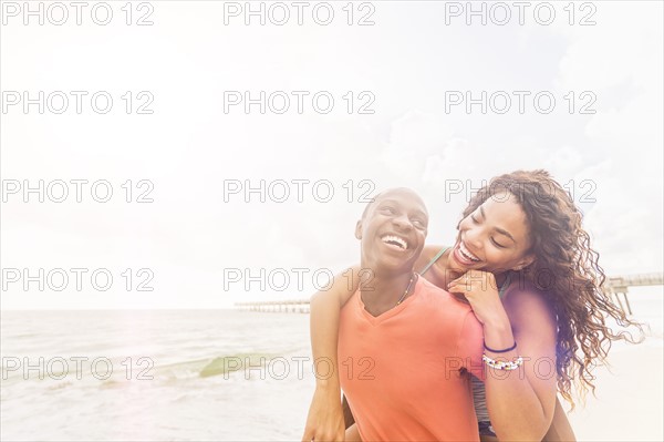 Young couple playing on beach