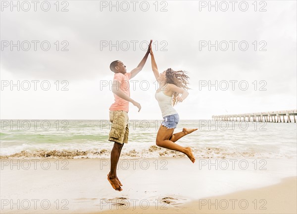 Young couple playing on beach