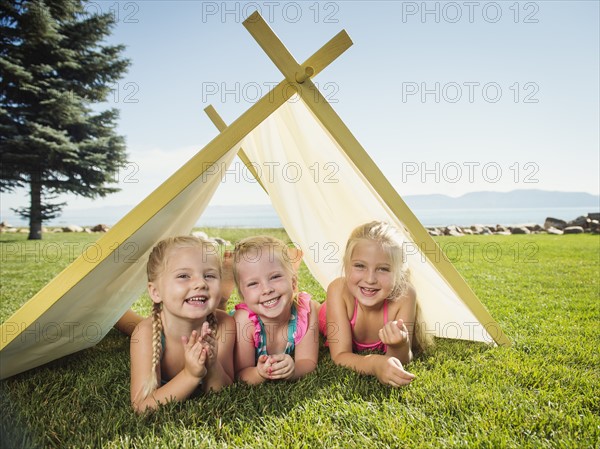 Three girls (2-3, 4-5) playing in tent