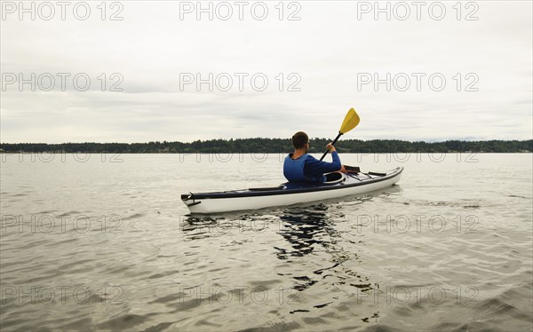 Man kayaking on lake