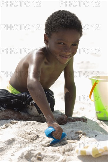 Portrait of boy (4-5) playing on beach