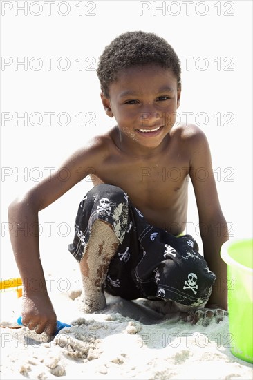 Portrait of boy (4-5) playing on beach