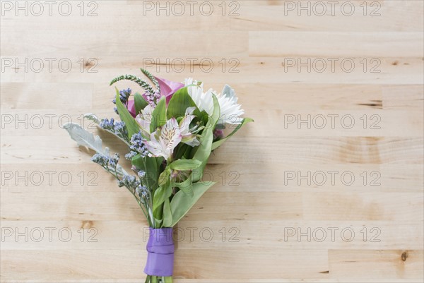 Studio shot of bunch of flowers against wooden surface