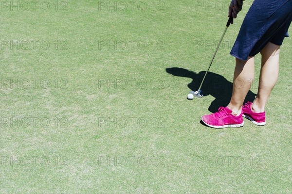 Low section of man playing golf