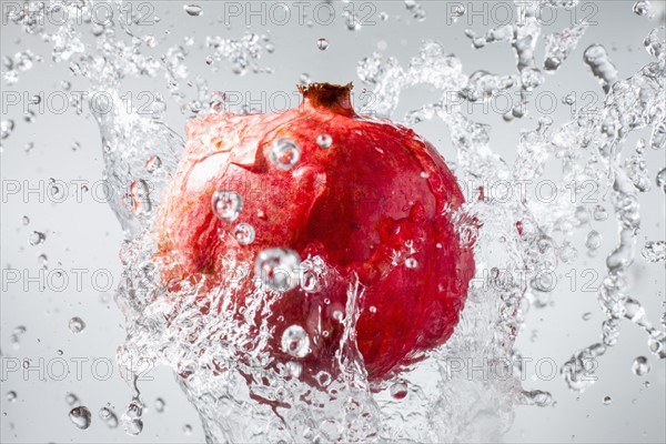 Droplets splashing on pomegranate