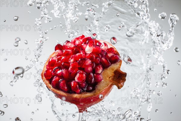 Droplets splashing on pomegranate