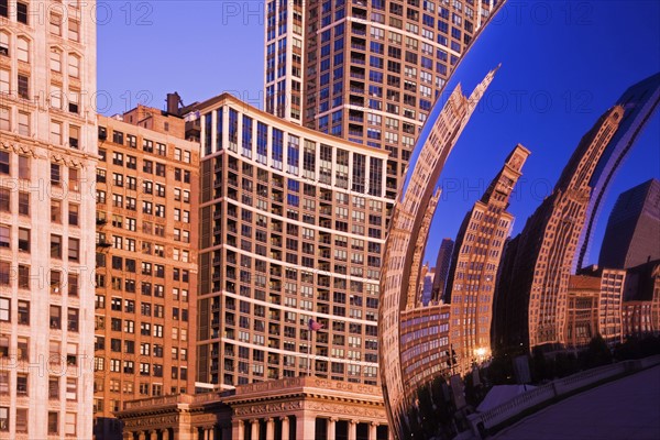 Skyscrapers reflecting in road mirror