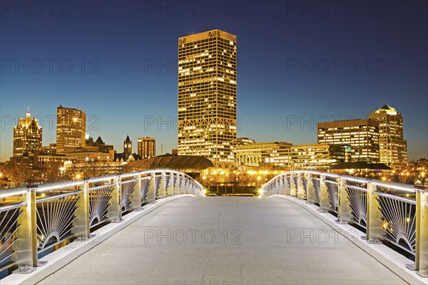 Pedestrian bridge with skyline in background