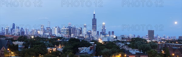 Panorama of city with rising moon